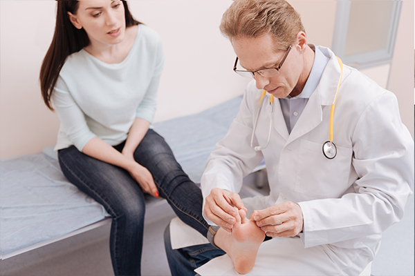 An image of a chiropodist inspecting someones foot